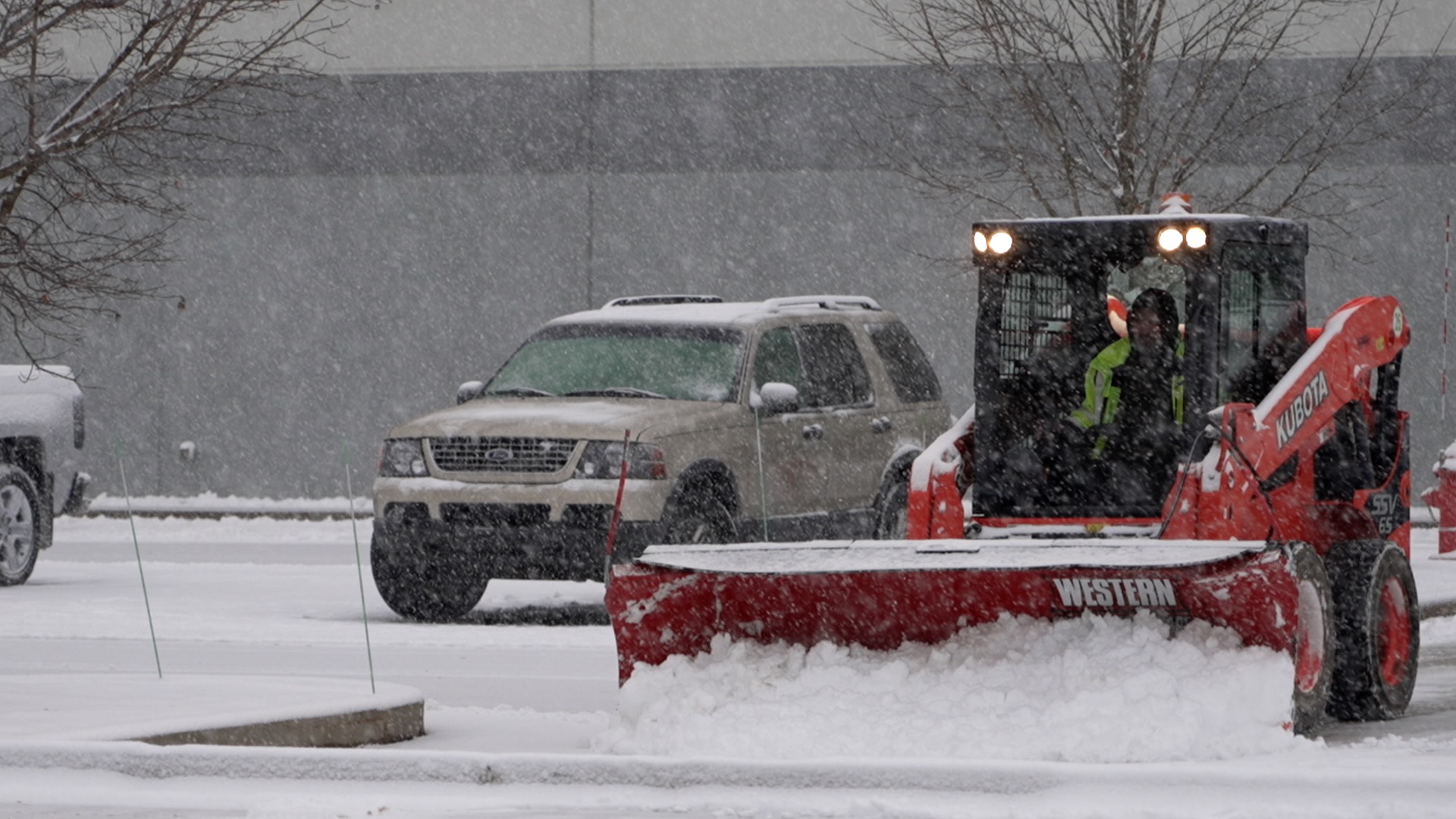 Snow plow clearing a commercial lot