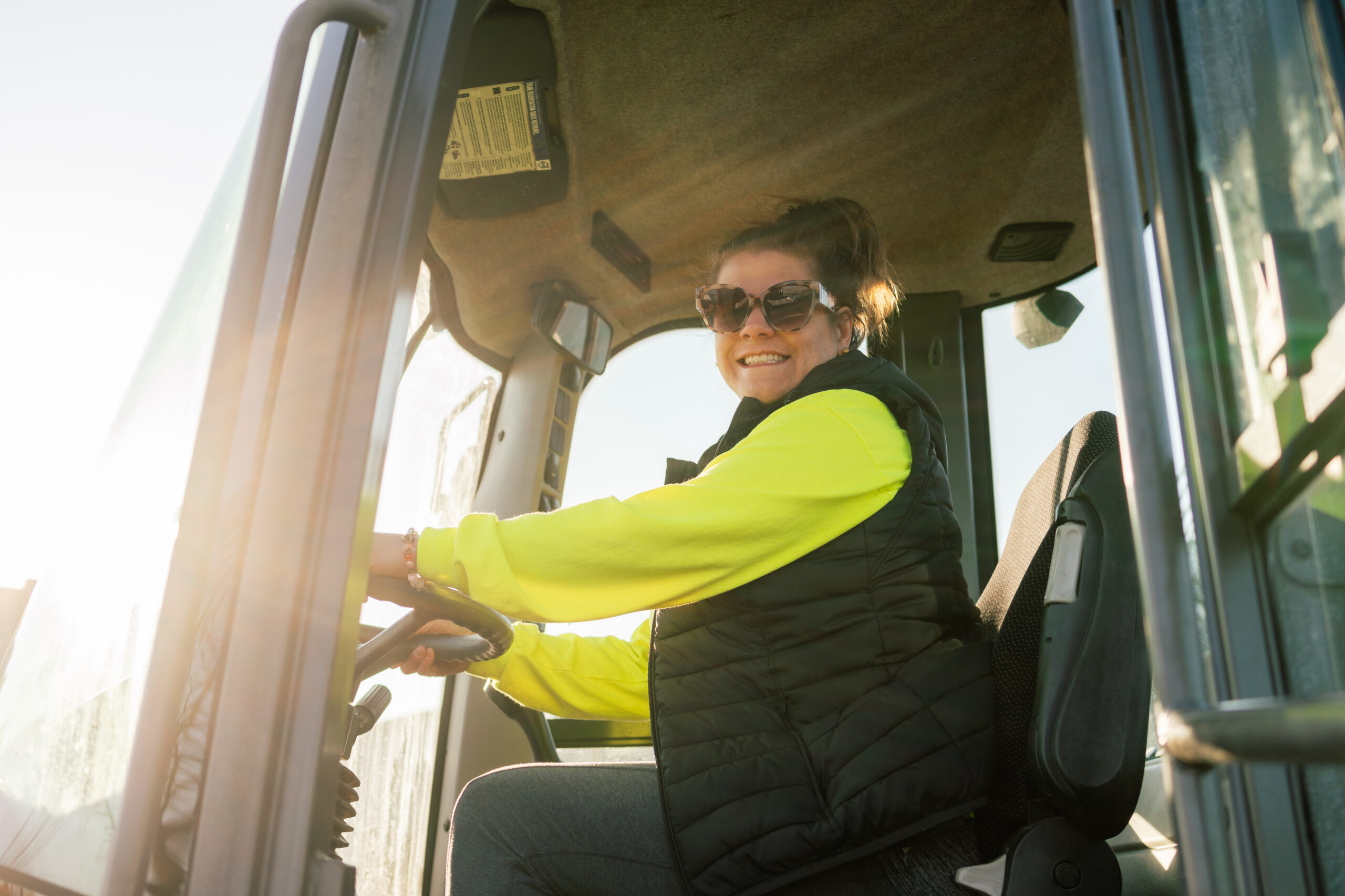 EMI operator in high-visibility gear in grounds equipment
